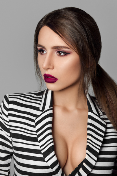 Professional model with bright evening make-up in striped jacket - Fotografie, Obrázek