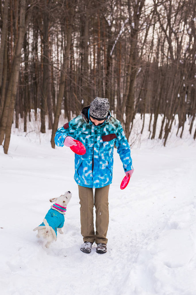 Middle aged woman outdoors with cute dog - Jack Russell Terrier in winter season - Foto, imagen