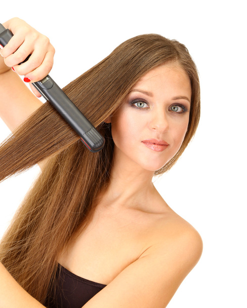 Woman doing hairstyle with hair straightener, isolated on white - Φωτογραφία, εικόνα
