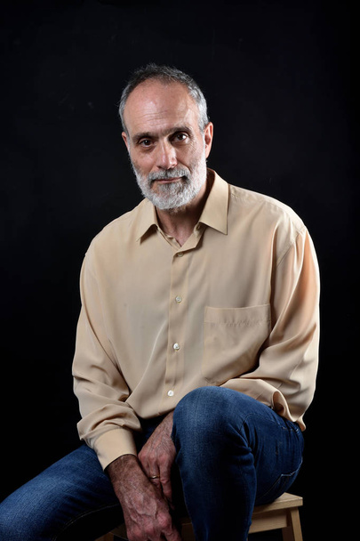 portrait of a middle aged man on black - Zdjęcie, obraz