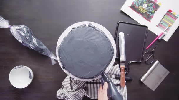 Step by step. Flat lay. Baker frosting multilayer chocolate cake with a black italian buttercream frosting - Footage, Video