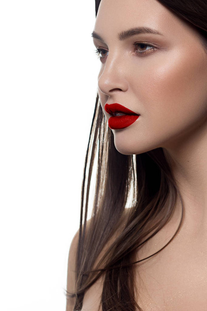 Closeup portrait of a woman with developing straight hair. Sweet tender young girl, brunette. Red lipstick on the lips, transparent transparent skin. Beauty, spa, injections, cosmetology, beautiful - Photo, Image