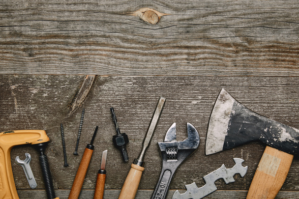 Top view of various carpentry tools on wooden background - Foto, imagen