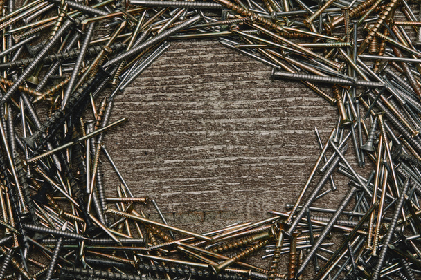 Top view of nails arranged on wooden table - Fotó, kép