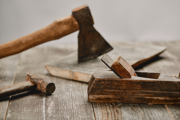 Close up view little wood construction, hammer and axe on wooden table on grey background - Foto, Bild