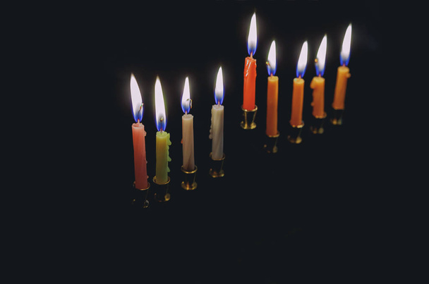 Colorful candles lite on the traditional Silver Hanukkah menorah - Photo, Image