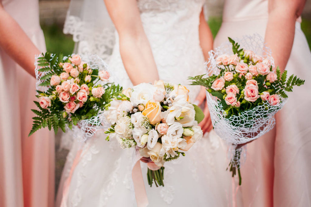 Mazzi di fiori nelle mani di sposa e damigelle d'onore
 - Foto, immagini