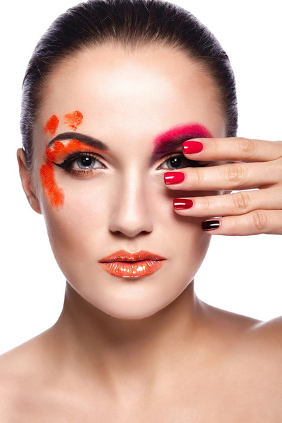 glamor closeup portrait of beautiful sexy brunette young woman model with orange lips,bright unusual creative plastic makeup, with perfect clean skin with colorful nails isolated on white - 写真・画像