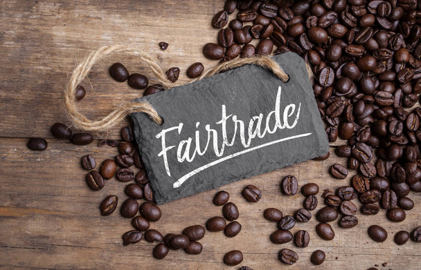 Chalkboard with coffee beans and a cup of coffee on natural brown wood Fair trade - Фото, зображення