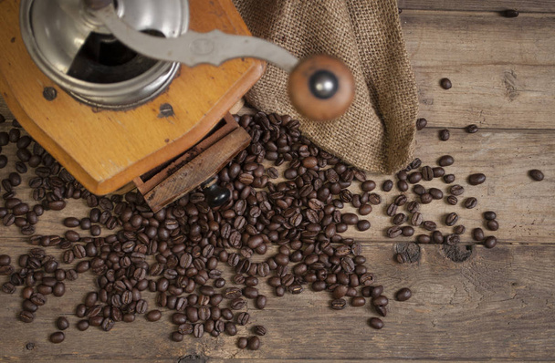 Chalkboard with coffee beans and a cup of coffee on natural brown wood - Fotoğraf, Görsel