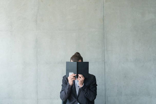 business man cover face notebook bookworm reading - Fotoğraf, Görsel