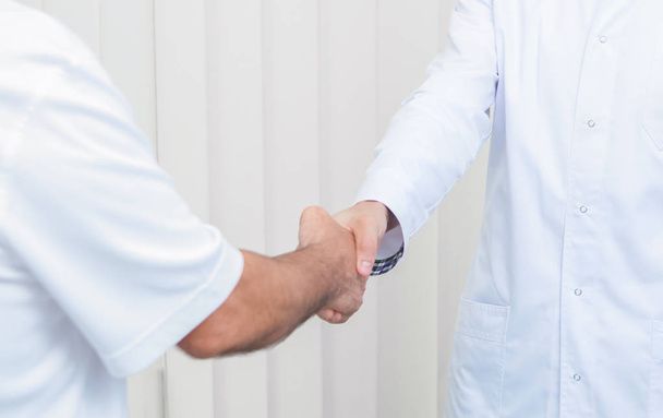 Close up of two doctors greeting each other at office. - Φωτογραφία, εικόνα