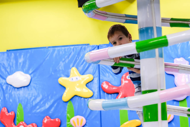 Indoor amusement park playground, colorful carousel, fun little kid, playing party, boy, child - Φωτογραφία, εικόνα