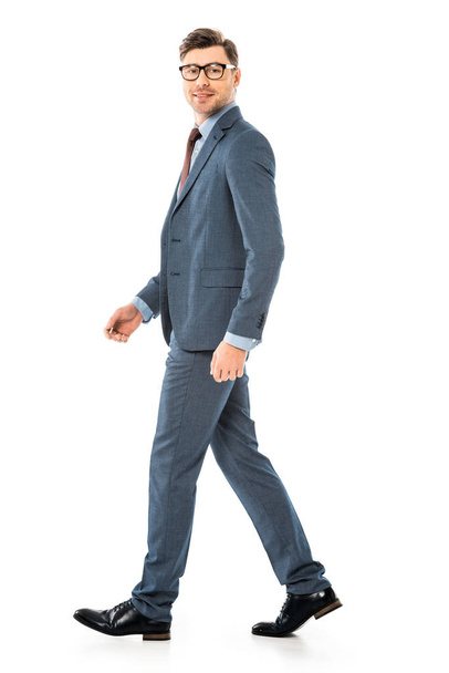 handsome adult businessman in glasses walking isolated on white - Foto, Imagem