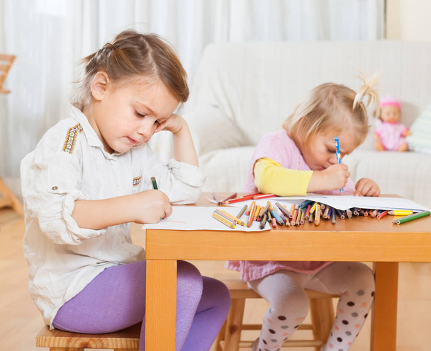  Two little girls sitting at home  and drawing.  - Photo, Image