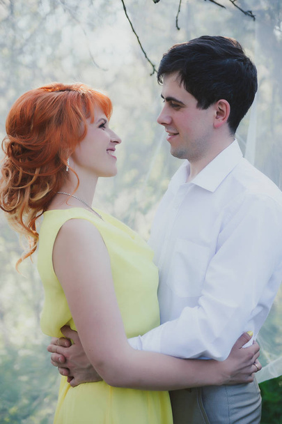 Portrait of   beautiful married couple against   backdrop of flowering gardens.  - Photo, Image