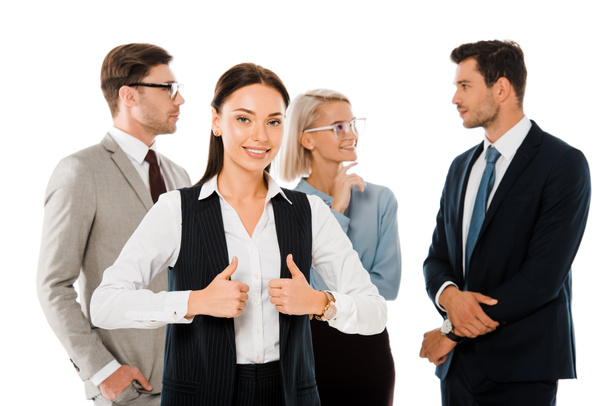 successful businesswoman showing thumbs up and standing with colleagues isolated on white - Foto, afbeelding