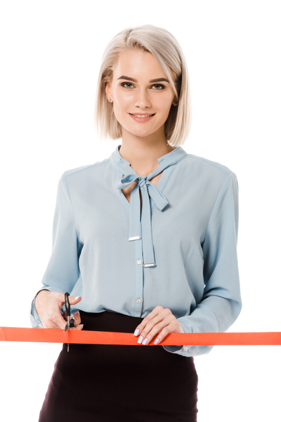 smiling businesswoman cutting red ribbon with scissors for grand opening, isolated on white - Foto, Imagem
