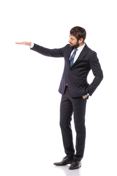 corporate man, elegant businessman standing on white background pointing or presenting his right empty side - Foto, Imagen