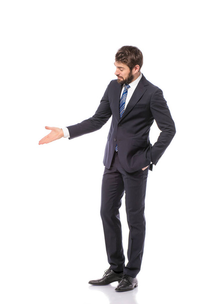 corporate man, elegant businessman standing on white background pointing or presenting his right empty side - Valokuva, kuva