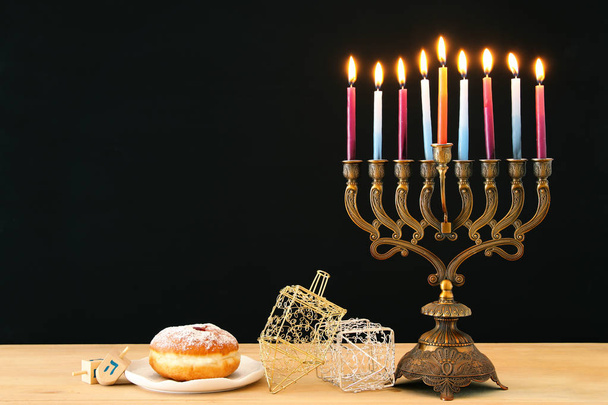 image of jewish holiday Hanukkah background with menorah (traditional candelabra) and burning candles - Photo, image