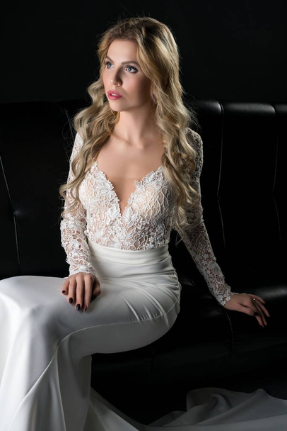 Pretty girl in an evening lace dress on the sofa - Foto, Imagem