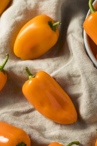 Raw Organic Sweet Orange Peppers Ready to Eat - 写真・画像