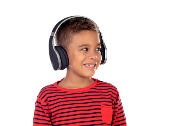 Latin child with headphones an red sweater isolated on a white background - Photo, Image