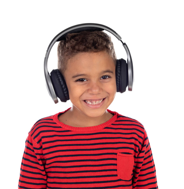 Latin child with headphones an red sweater isolated on a white background - Photo, Image