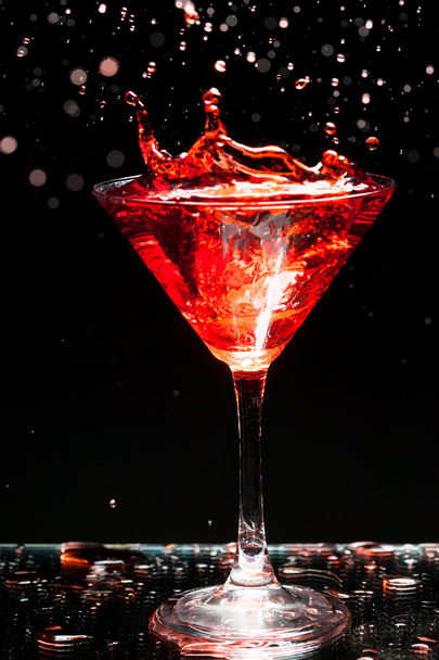 red splashing cocktail on black - Fotoğraf, Görsel