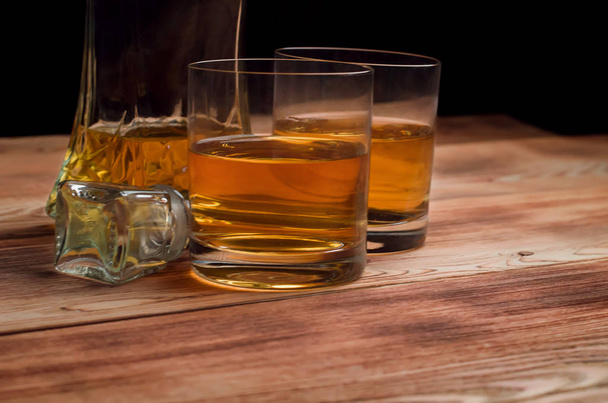 Glasses for whiskey on a wooden table - Foto, imagen