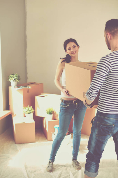 Happy young couple unpacking or packing boxes and moving into a new home. young couple - Fotoğraf, Görsel