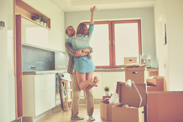 Portrait of young couple moving in new home. Young couple - Fotoğraf, Görsel