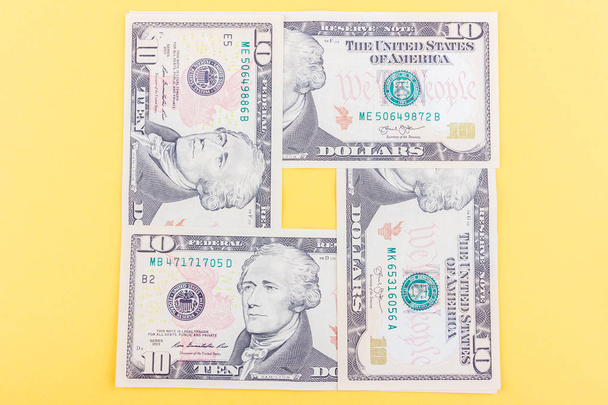 Различные американские доллары на светло-желтой основе, вид сверху
 - Фото, изображение