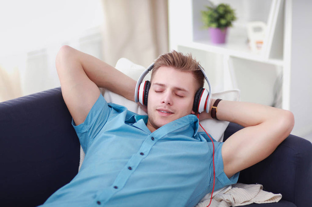 Man listening music with headphones at home - Photo, image