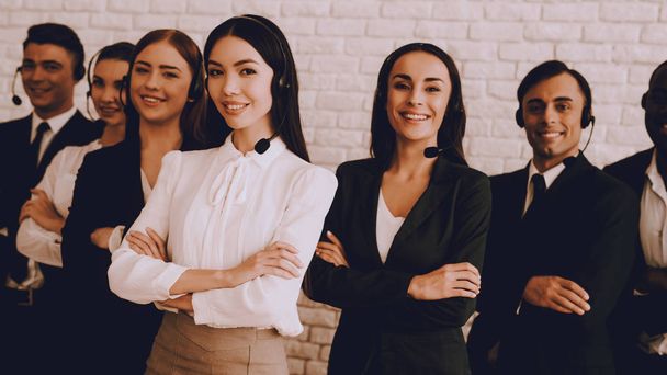 Young Smiling Managers Standing in Modern Office. Training in Office. Modern Office Concept. Smiling Worker. Standing in Room. Woman in White Shirt. Man in Black Suit. White Wall in Office. - Foto, immagini