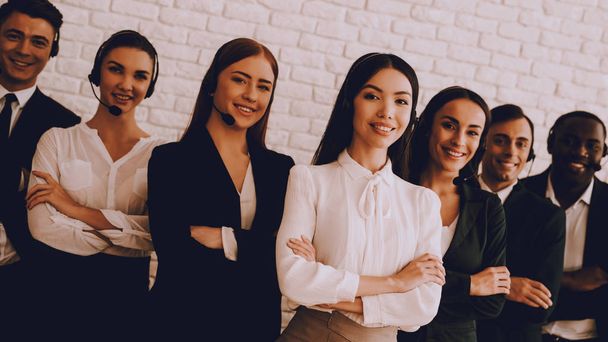 Young Smiling Managers Standing in Modern Office. Training in Office. Modern Office Concept. Smiling Worker. Standing in Room. Woman in White Shirt. Man in Black Suit. White Wall in Office. - Foto, Imagen