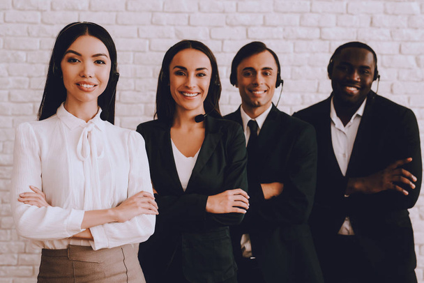 Young Smiling Managers Standing in Modern Office. Training in Office. Modern Office Concept. Smiling Worker. Standing in Room. Woman in White Shirt. Man in Black Suit. White Wall in Office. - Foto, imagen
