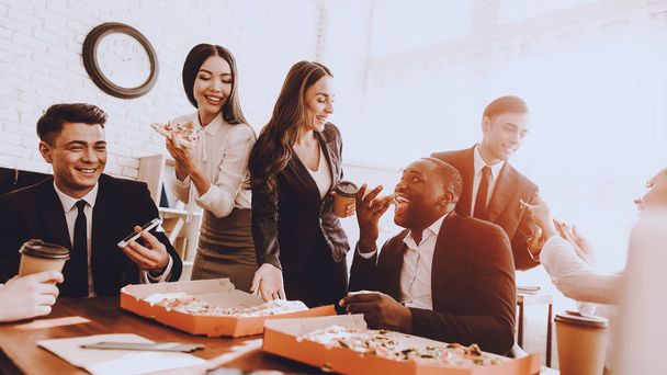 Team of Managers Have Lunch in Modern Office. Rest after Business Meeting. Modern Office Concept. Cooperation with Colleagues. Businessman with Team. Pizza in Box. Businessman in Suit. - Foto, Imagen