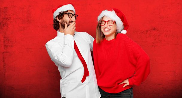 young couple expressing christmas concept. Couple and background in different layers. - Фото, изображение