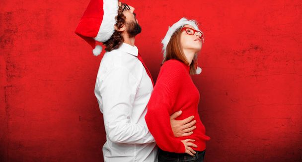 young couple expressing christmas concept. Couple and background in different layers. - Fotografie, Obrázek