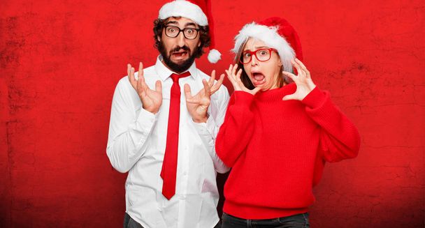 young couple expressing christmas concept. Couple and background in different layers. - 写真・画像