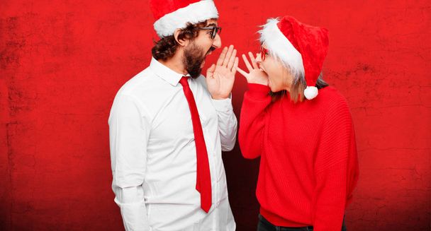 young couple expressing christmas concept. Couple and background in different layers. - Φωτογραφία, εικόνα