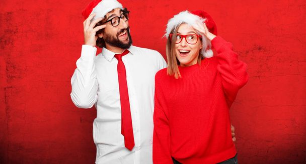 young couple expressing christmas concept. Couple and background in different layers. - Foto, Imagen