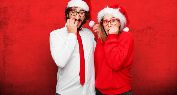 young couple expressing christmas concept. Couple and background in different layers. - Fotó, kép