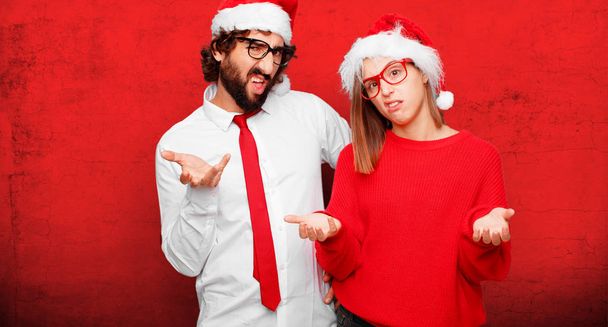 young couple expressing christmas concept. Couple and background in different layers. - Foto, immagini