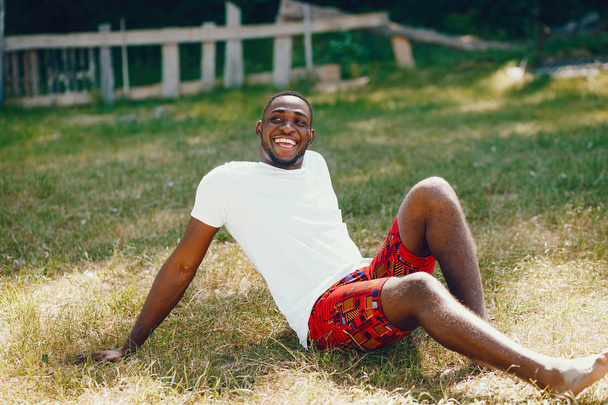 Black guy in a summer park - Fotó, kép