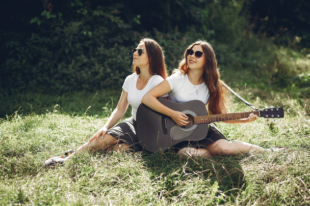 Cute sisters in a park - Фото, изображение