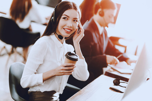 Team of Young Managers Working in Call Center. Manager with Computer. Businessman on Workplace. Consultant with Microphone. Customer Service Concept. Woman in Headphones. Operator in Office. - 写真・画像