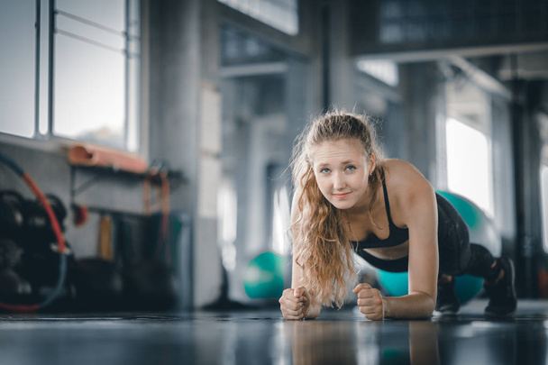 Portrait young attractive healthy woman body curve fitness doing push ups exercises workout with ball in gym. People beauty perfect body slim fitness girl. Freedom happy and relax lifestyle healthcare concept - Foto, afbeelding